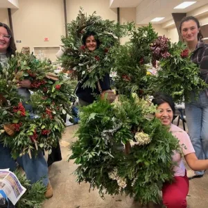 Women displaying wreaths they made
