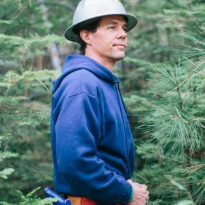 A headshot of Forestry Specialist, Rob York. He is in the forest holding forest inventory equipment.
