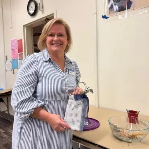 Blonde woman holding a sachet