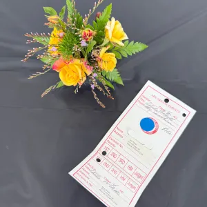 A tiny bouquet of yellow rose that was judged in a contest.