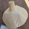 A white garlic bulb with a smooth, textured surface sits on a wooden table.