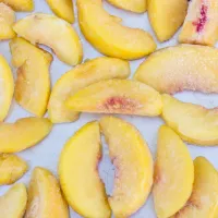 Individual Quick Freeze method- frozen peaches on tray. 
